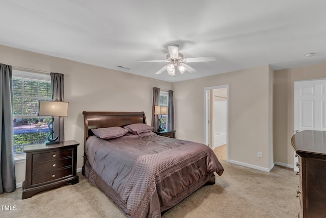 bedroom featuring a ceiling fan, baseboards, visible vents, and light carpet