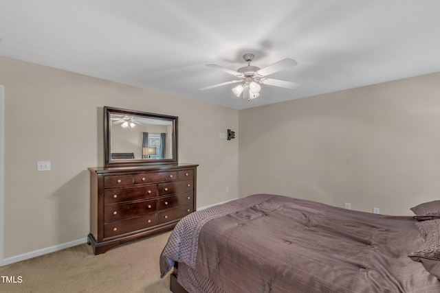 bedroom with baseboards, ceiling fan, and light carpet