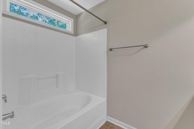 full bath with  shower combination and baseboards