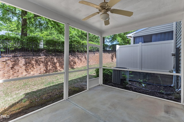 unfurnished sunroom with a ceiling fan