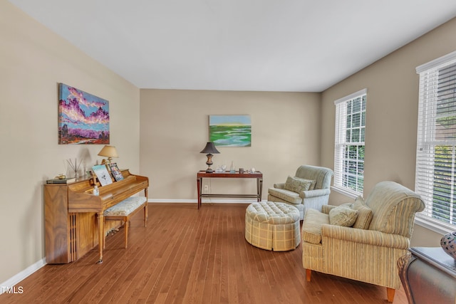 living area featuring wood finished floors and baseboards