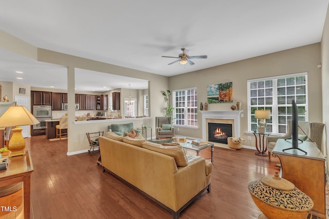 living room featuring ceiling fan, hardwood / wood-style floors, a fireplace with flush hearth, healthy amount of natural light, and recessed lighting