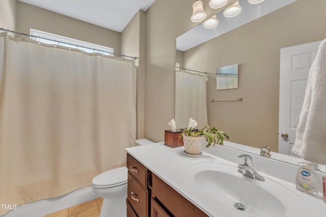 bathroom with tile patterned flooring, vanity, and toilet