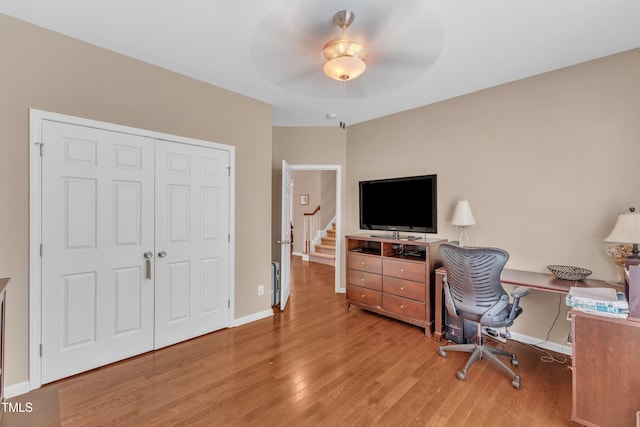 office space with wood finished floors, baseboards, and ceiling fan