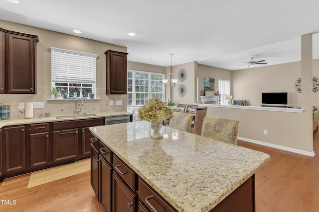 kitchen featuring a sink, light wood-type flooring, ceiling fan, tasteful backsplash, and recessed lighting