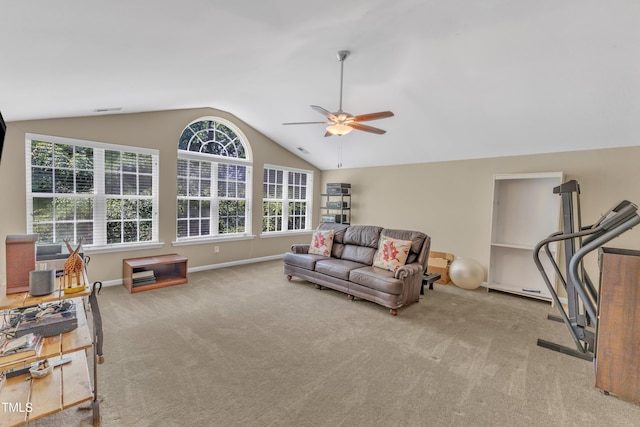 living room featuring lofted ceiling, a ceiling fan, carpet flooring, and baseboards