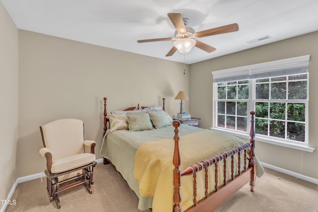 carpeted bedroom featuring baseboards and a ceiling fan