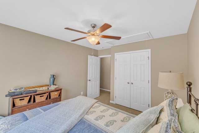 bedroom with attic access, a closet, ceiling fan, and light carpet