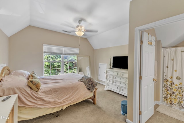 bedroom featuring lofted ceiling, ceiling fan, and light colored carpet