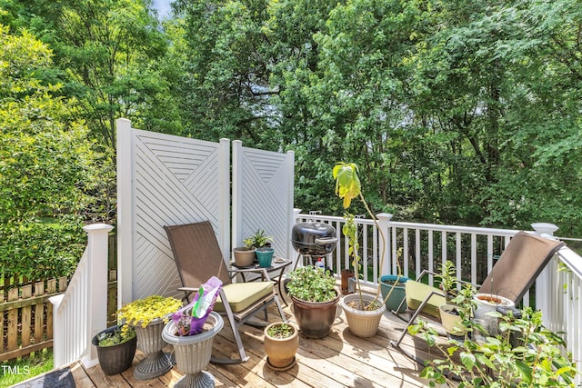 view of wooden balcony featuring a wooden deck and a grill