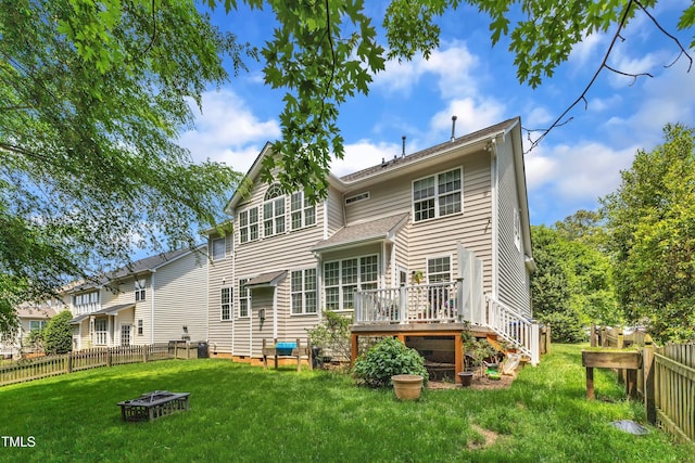 rear view of property with a fire pit, a wooden deck, and crawl space