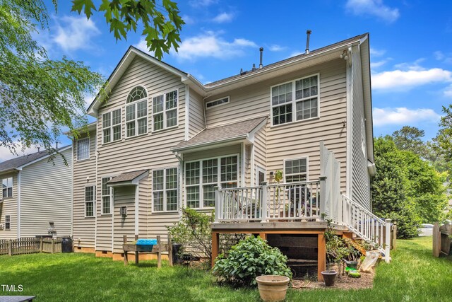 back of property with a lawn, a deck, crawl space, and stairway