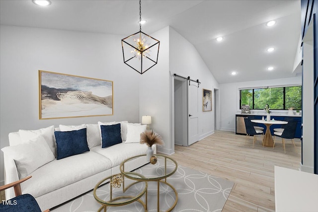 living area featuring a barn door, baseboards, high vaulted ceiling, a notable chandelier, and light wood-style floors