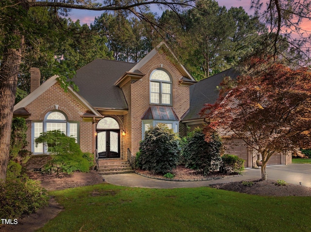 view of front of property featuring french doors, brick siding, a chimney, and a shingled roof