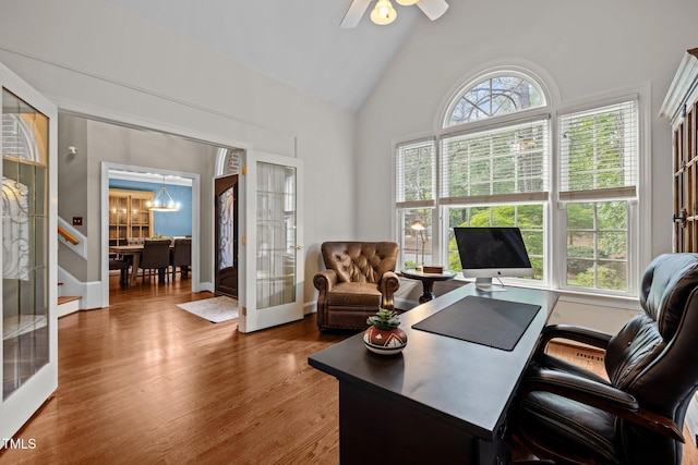 office area with french doors, wood finished floors, a chandelier, a ceiling fan, and high vaulted ceiling