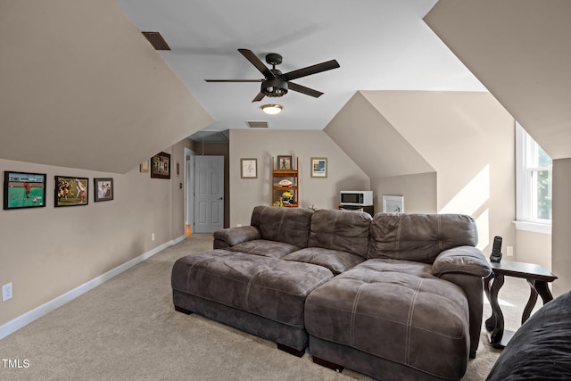 living room featuring carpet flooring, a ceiling fan, baseboards, and vaulted ceiling