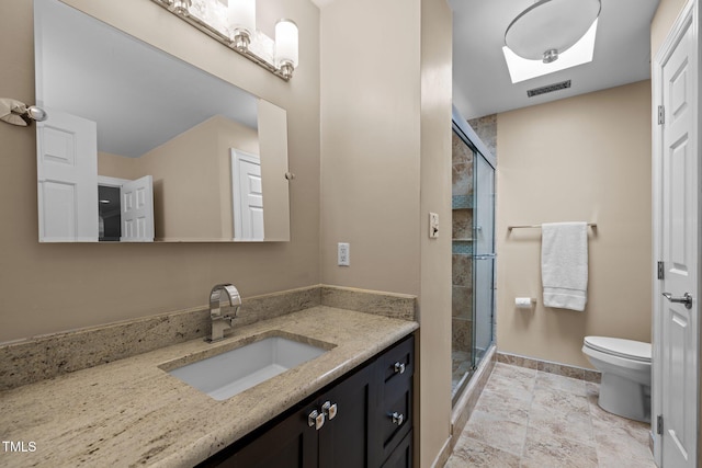bathroom with toilet, a shower stall, vanity, and baseboards
