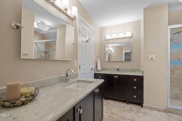 full bath featuring a stall shower and two vanities