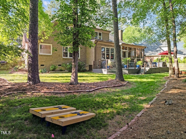back of house with crawl space, a sunroom, brick siding, and a chimney