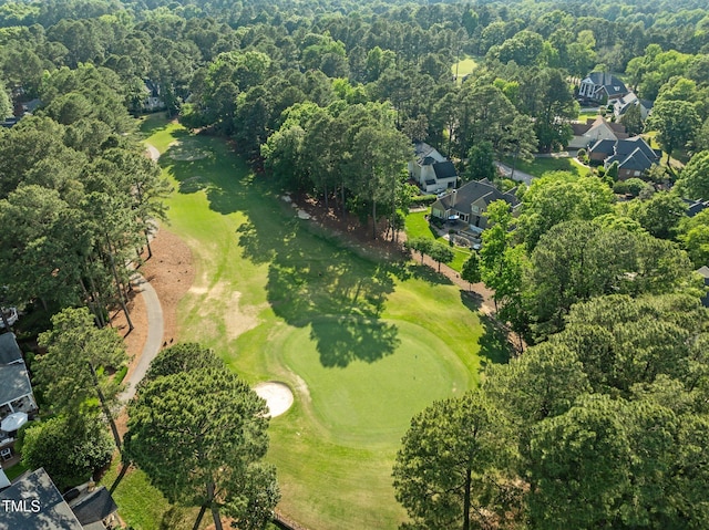 aerial overview of property's location with a golf course and nearby suburban area