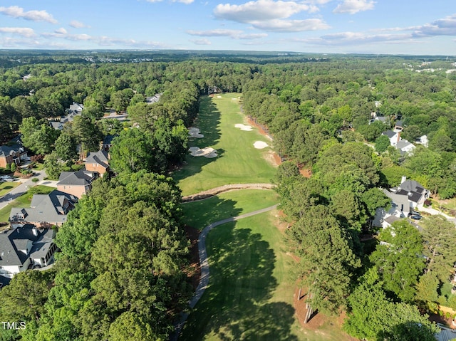 aerial overview of property's location featuring a forest, a golf club, and nearby suburban area