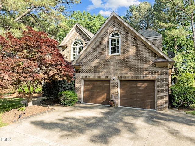 view of front of home with brick siding, driveway, and a shingled roof