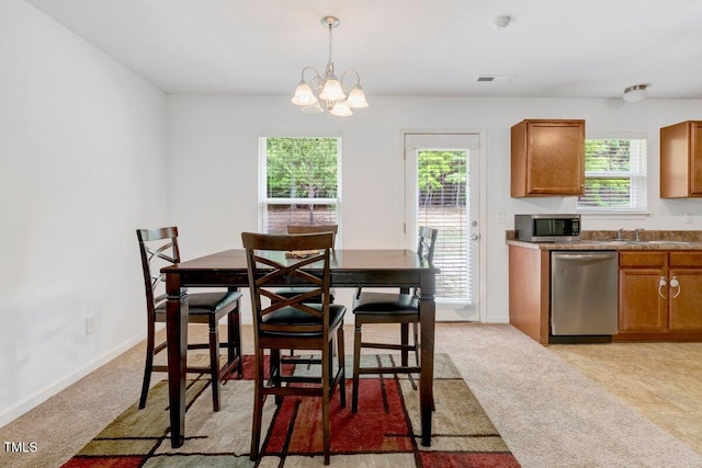 dining area with a notable chandelier, visible vents, light carpet, and baseboards