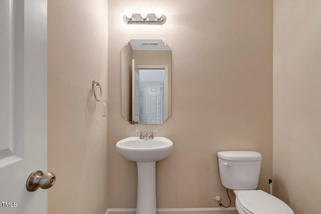half bathroom with toilet and visible vents