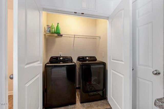 clothes washing area featuring laundry area, separate washer and dryer, and visible vents