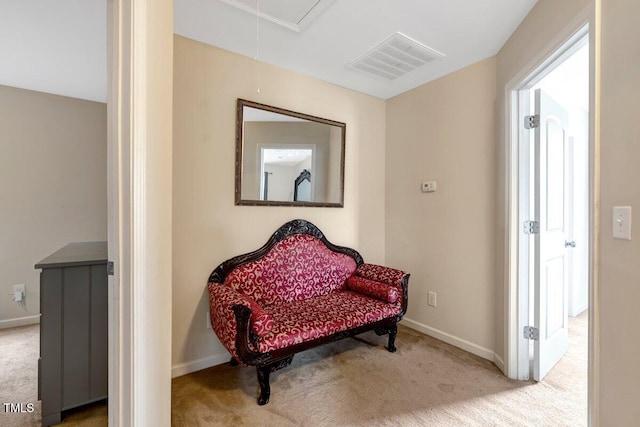 living area featuring baseboards, attic access, carpet flooring, and visible vents