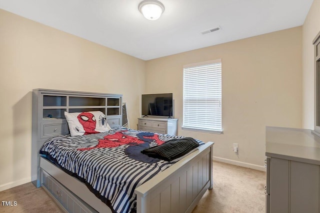 bedroom featuring baseboards, visible vents, and light carpet