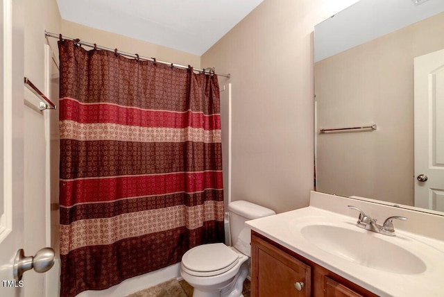 bathroom featuring vanity, a shower with shower curtain, and toilet