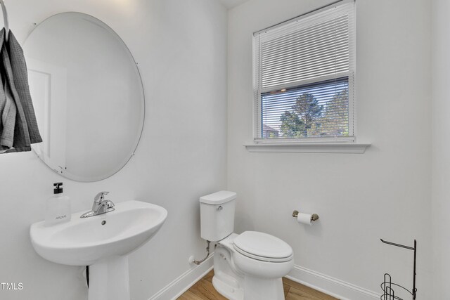 162 Channel Drop Dr, Clayton, NC 27520 - bathroom with a sink, baseboards, toilet, and wood finished floors