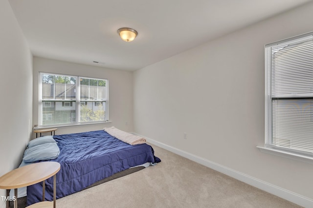 carpeted bedroom featuring baseboards