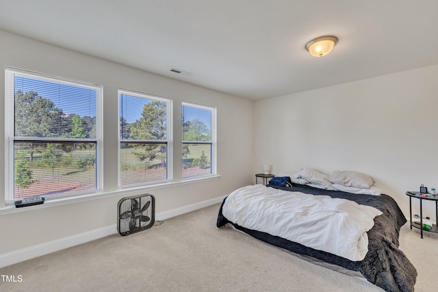 bedroom with visible vents, carpet flooring, and baseboards