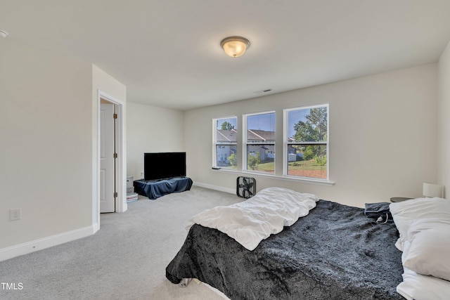 bedroom with baseboards, carpet, and visible vents