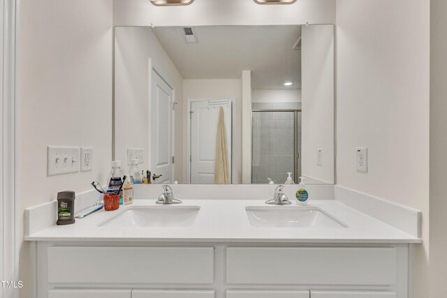 162 Channel Drop Dr, Clayton, NC 27520 - bathroom featuring double vanity, visible vents, a sink, and a stall shower