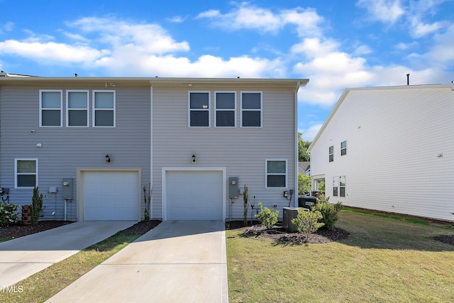 view of front of home featuring concrete driveway, an attached garage, a front yard, and central air condition unit