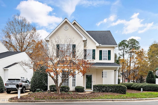 traditional home with roof with shingles