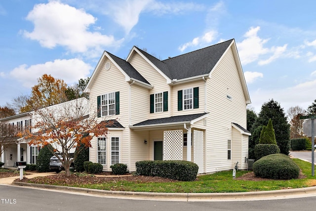 traditional home with roof with shingles and central air condition unit