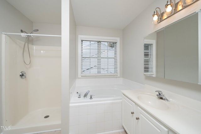 full bathroom featuring walk in shower, a garden tub, and vanity