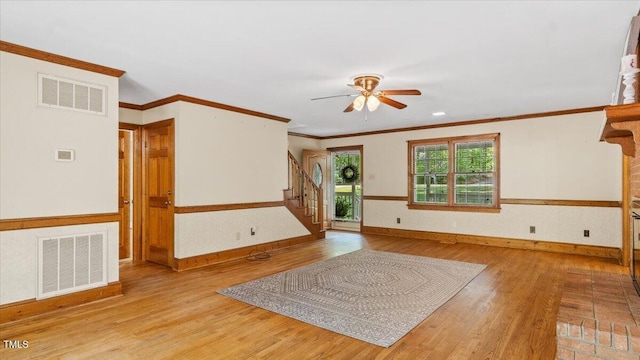 interior space featuring visible vents, light wood-style flooring, ceiling fan, and stairs