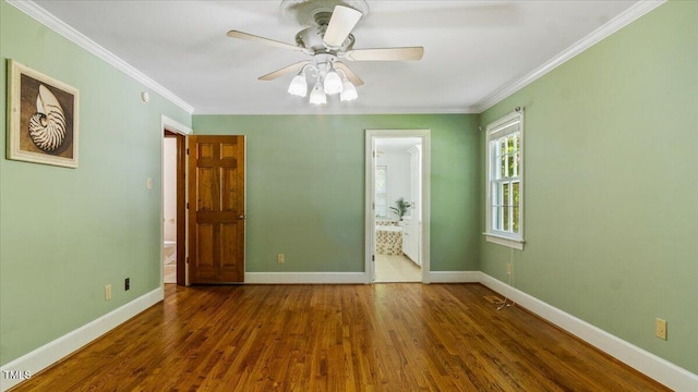 unfurnished bedroom featuring crown molding, baseboards, and wood finished floors