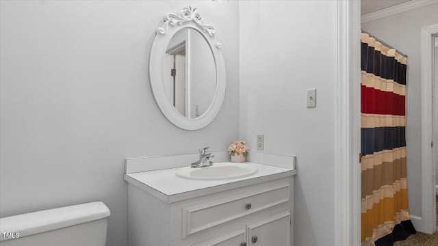 bathroom with crown molding, toilet, curtained shower, and vanity