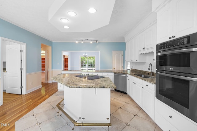 kitchen featuring dishwasher, a sink, double wall oven, black electric cooktop, and crown molding