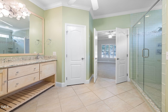 bathroom with ornamental molding, a ceiling fan, tile patterned floors, baseboards, and a stall shower