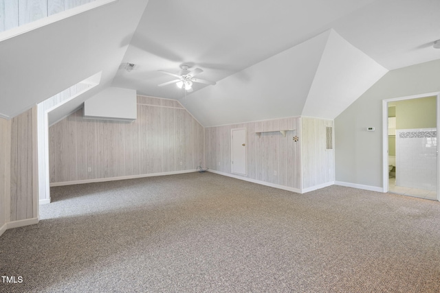 bonus room featuring carpet flooring, vaulted ceiling, a ceiling fan, and baseboards