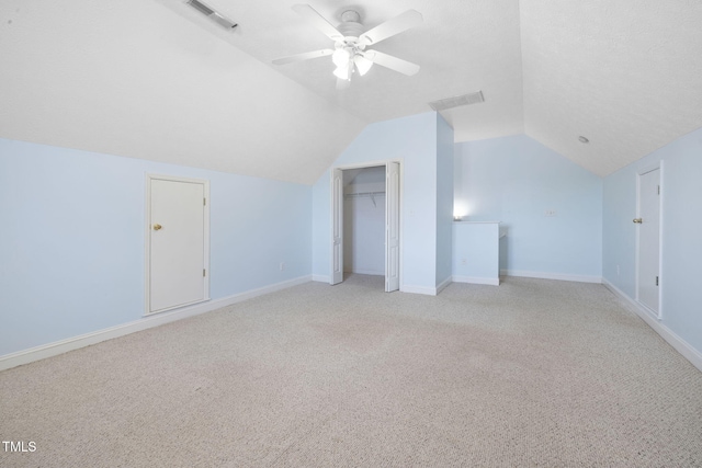 bonus room with lofted ceiling, light carpet, ceiling fan, and baseboards