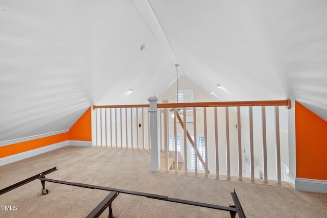 bonus room featuring lofted ceiling, carpet, and baseboards