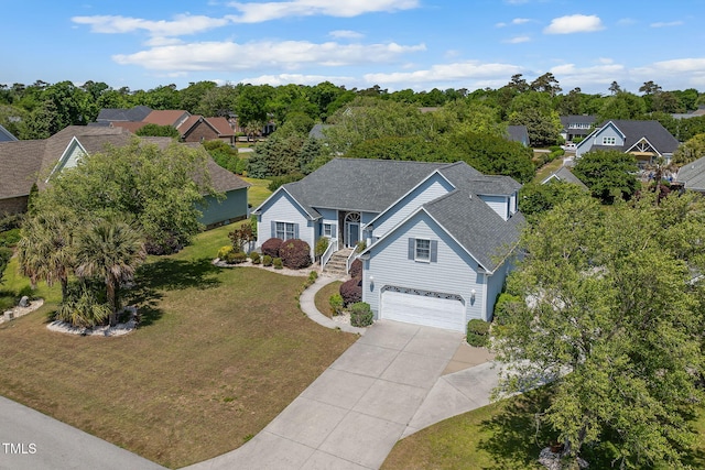 aerial view of property and surrounding area with a tree filled landscape